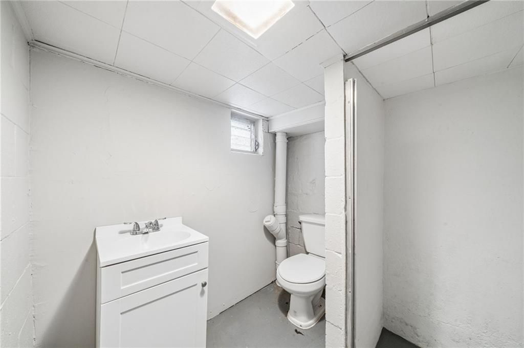 620 Broadway Avenue McKees Rocks, PA 15136 - Photo 15 of 18 a bathroom with a toilet sink and a mirror