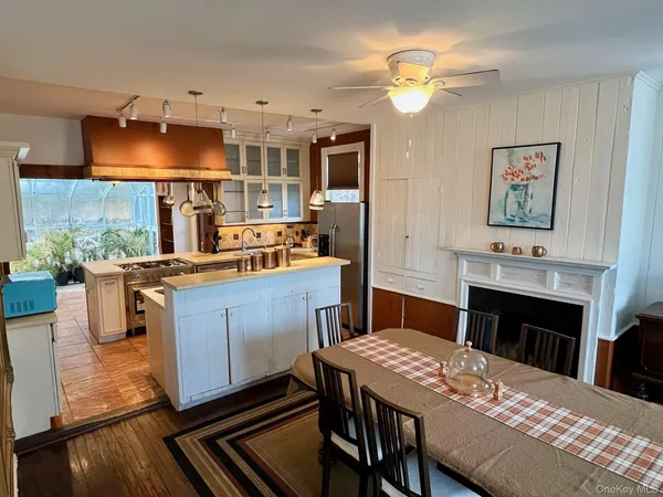 a kitchen with a table chairs and a chandelier