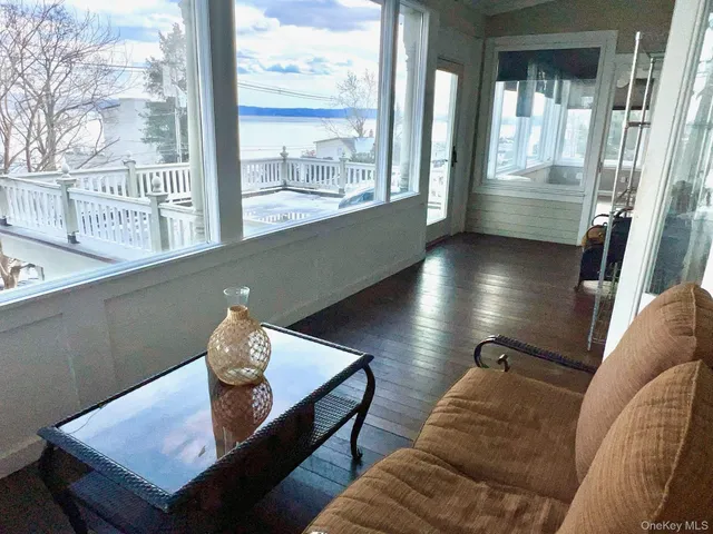 a living room filled with furniture and a floor to ceiling window