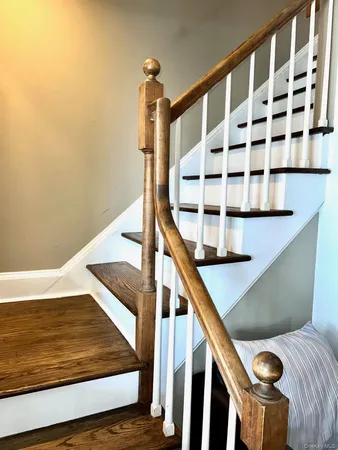 a bedroom with a large bed and a flat tv screen on dresser