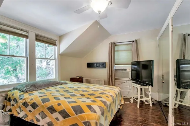 a spacious bedroom with a bed couch and a window