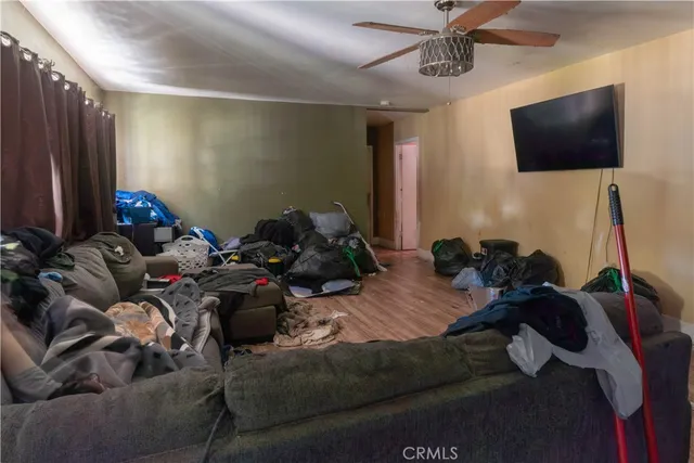 a bed room with a bed a television and a window