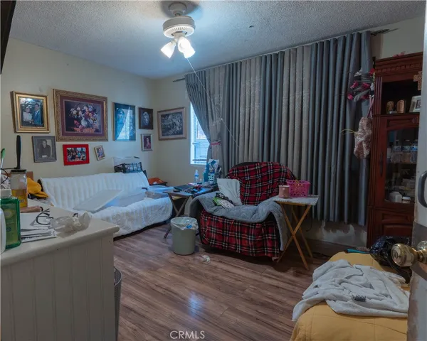 a bedroom with furniture and a wooden floor