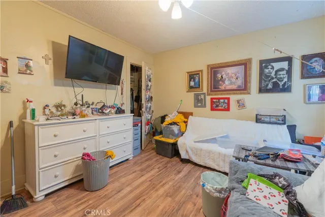 a bed room with a bed a flat screen tv and dresser