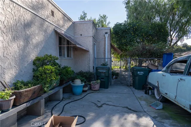 a view of a backyard with plants and a patio