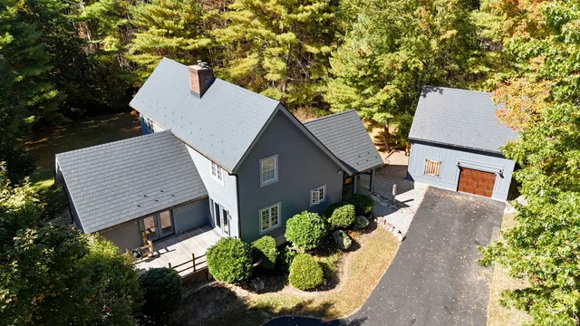an aerial view of a house with a yard and garden