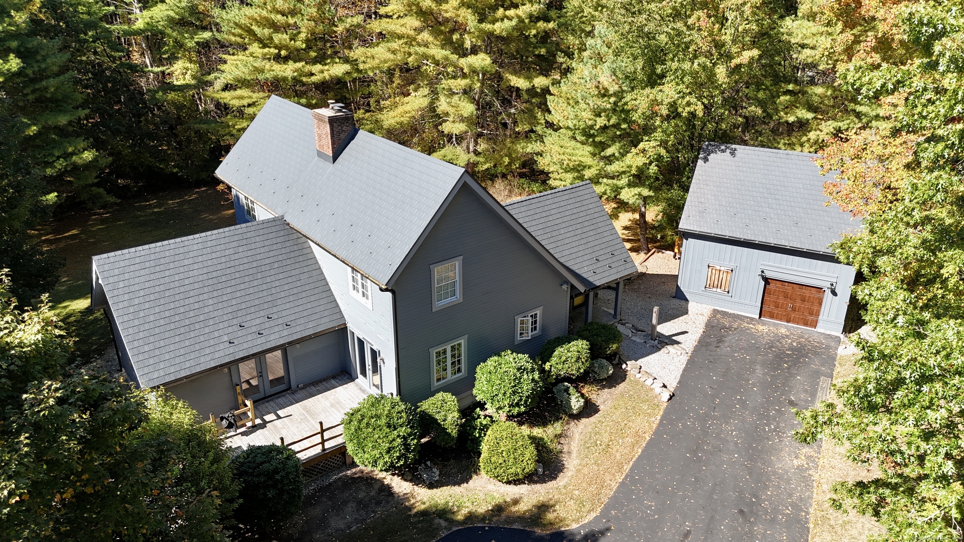 an aerial view of a house with a yard and garden