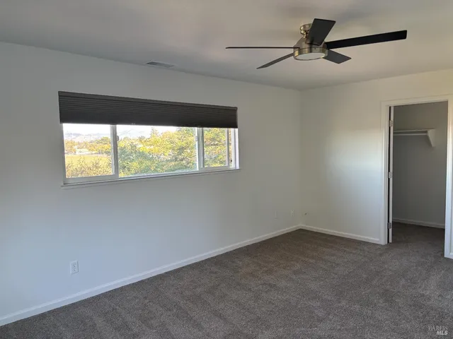 a bathroom with a sink and two window