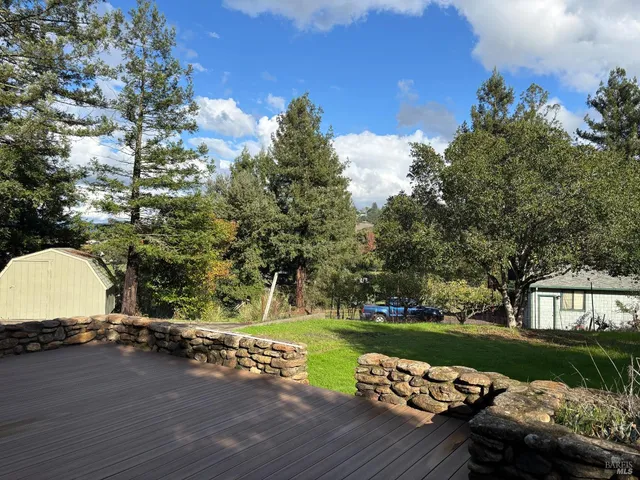a view of a street with a car parked on the road