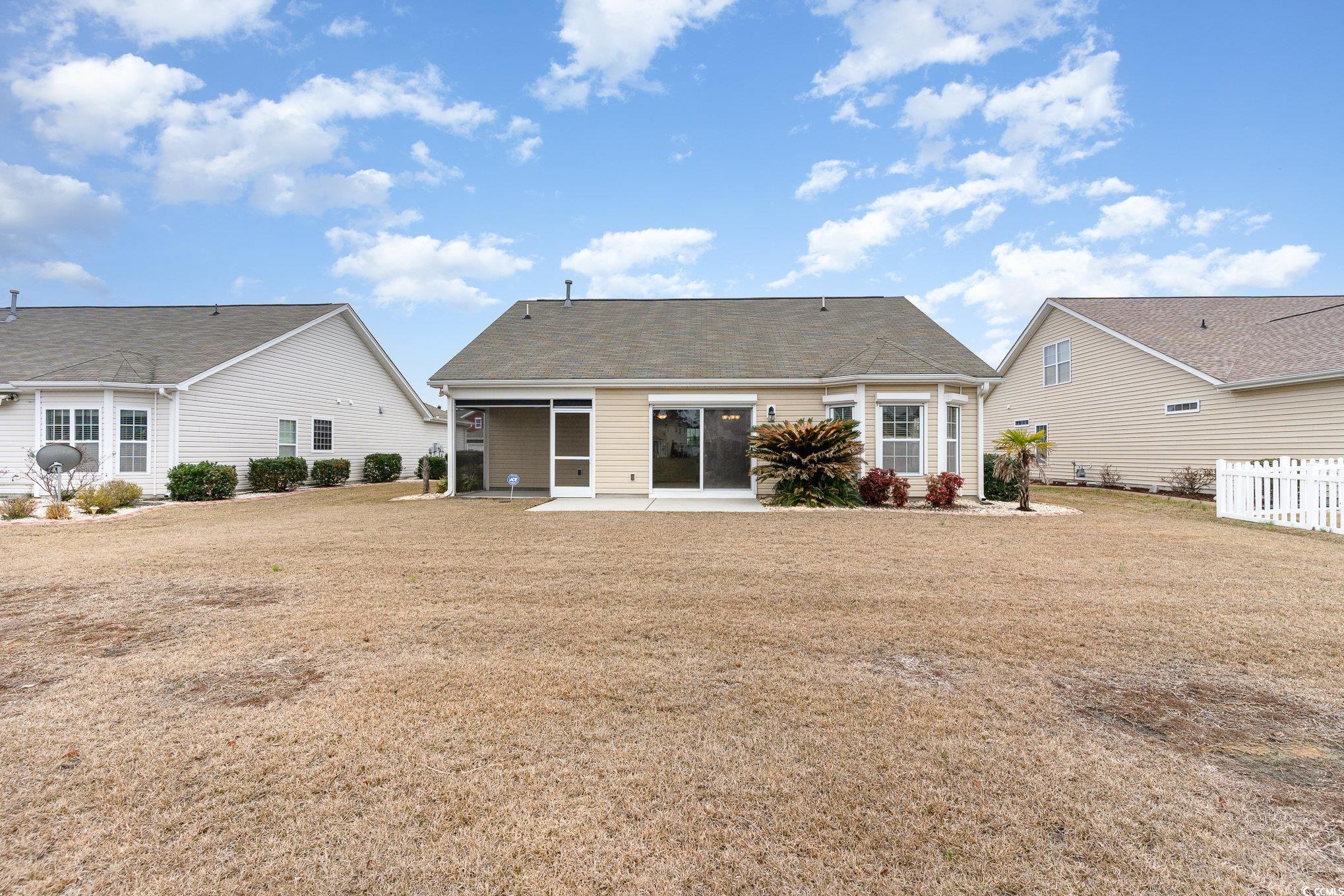 654 Old Castle Loop Myrtle Beach, SC 29579 - Photo 30 of 39 Rear view of house featuring a yard, a patio area,