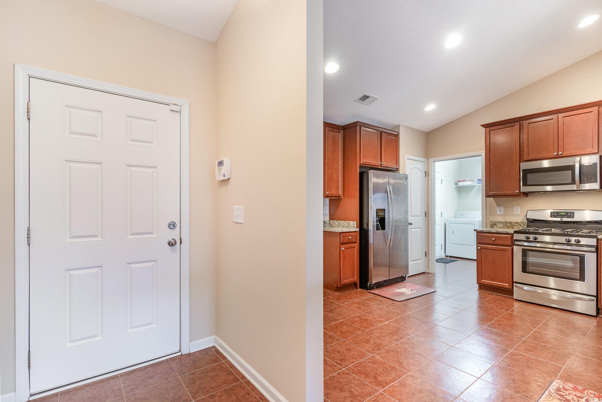654 Old Castle Loop Myrtle Beach, SC 29579 - Photo 6 of 39 Kitchen with brown cabinets, washer / dryer, visib