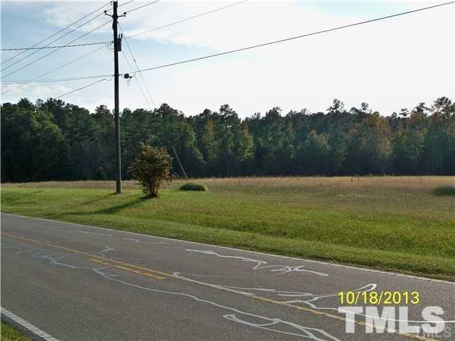 1625 Pearces Road Zebulon, NC 27597 - Photo 2 of 6 a view of a field with a tree in the background