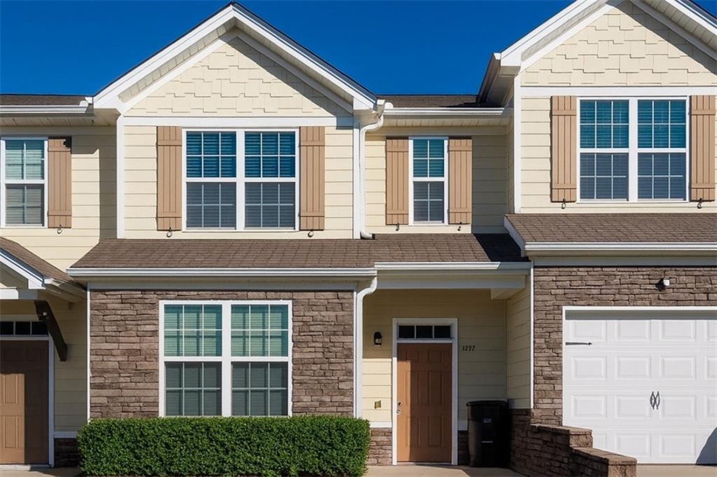 a view of a brick house with large windows