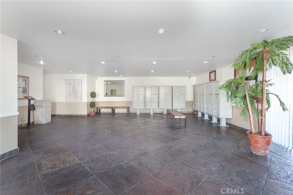 19350 Sherman Way, Unit 124 Reseda, CA 91335 - Photo 24 of 26 a lobby with furniture and a potted plant