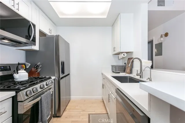 a kitchen with stainless steel appliances granite countertop a sink and a stove