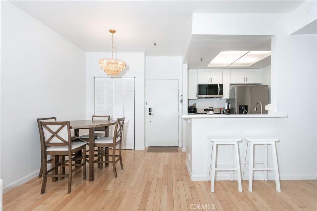 19350 Sherman Way, Unit 124 Reseda, CA 91335 - Photo 8 of 26 a view of kitchen with cabinets and wooden floor
