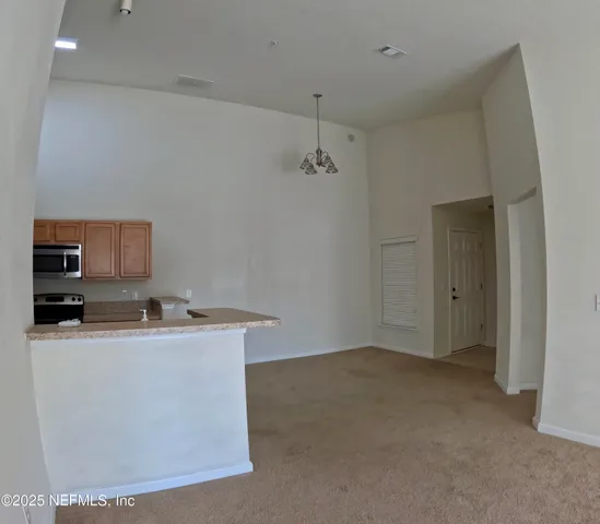a room with a sink a mirror and cabinets