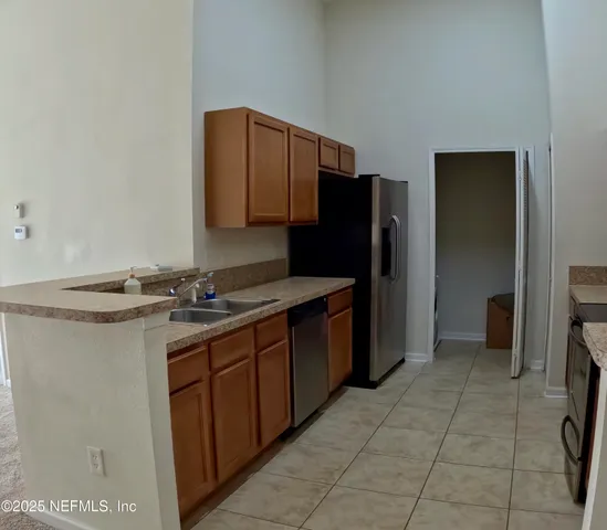 a kitchen with a sink and a refrigerator