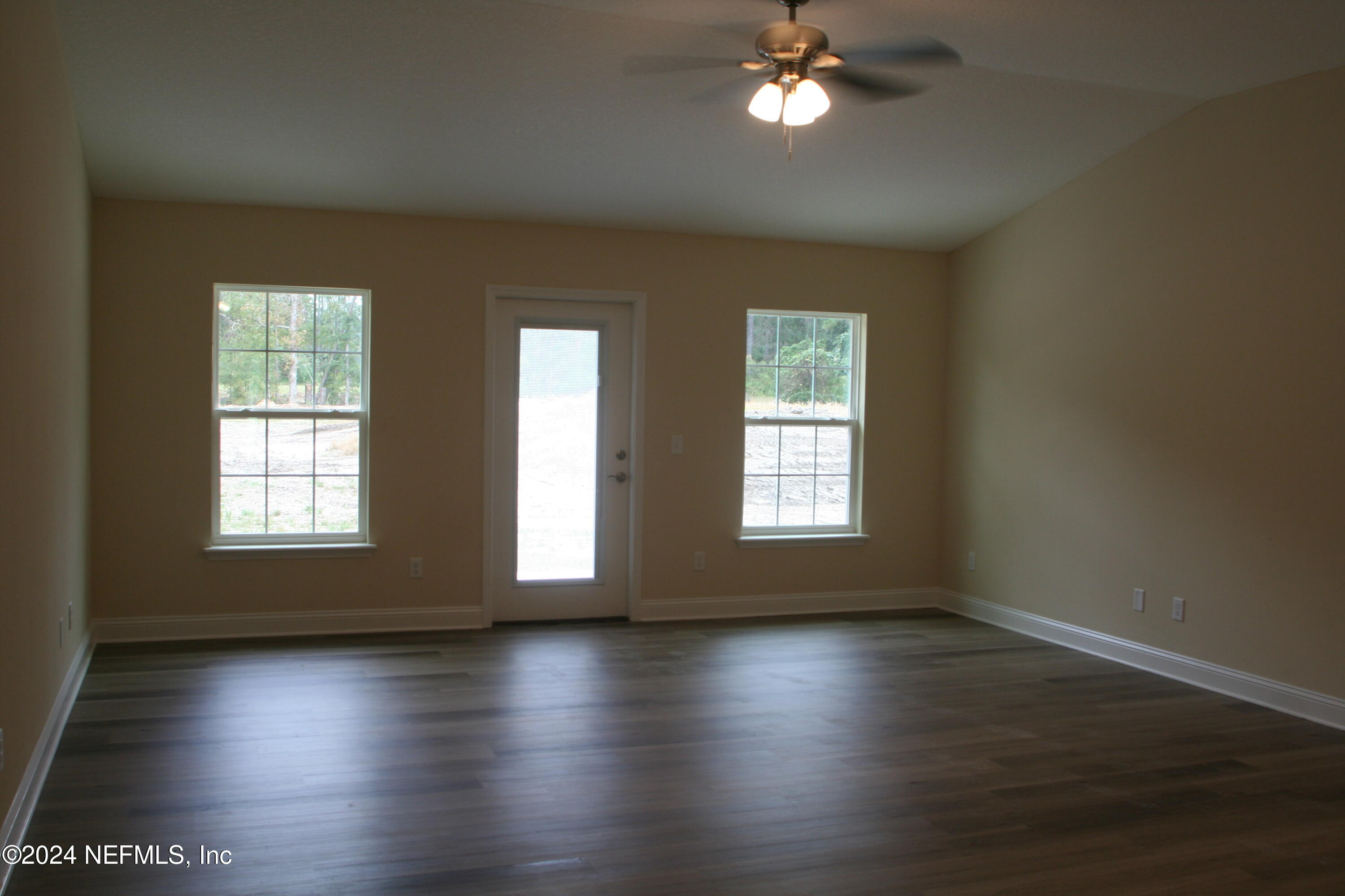 54516 Church Road Callahan, FL 32011 - Photo 20 of 39 a view of an empty room with wooden floor and a window