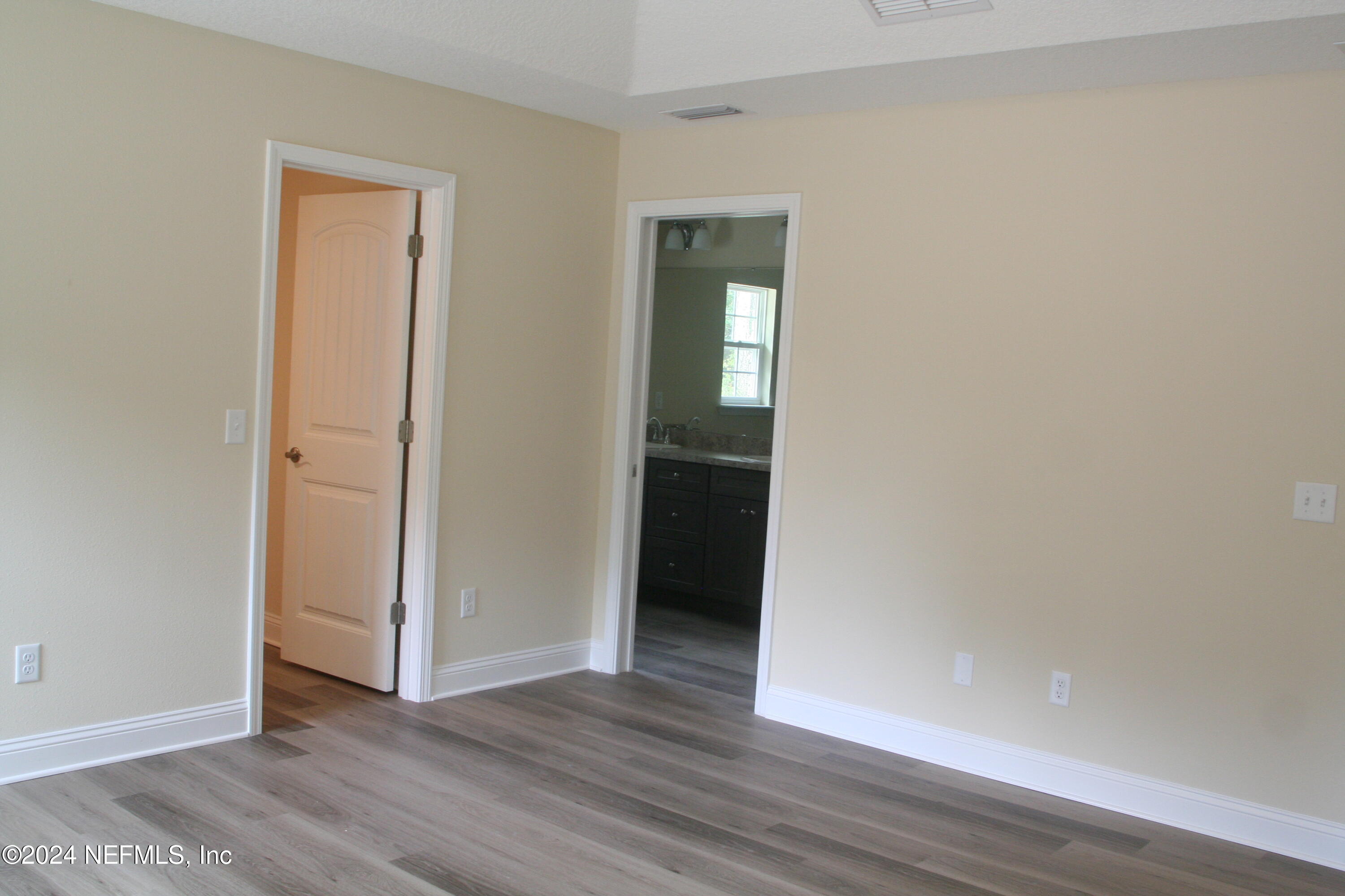 54516 Church Road Callahan, FL 32011 - Photo 31 of 39 an empty room with wooden floor and closet
