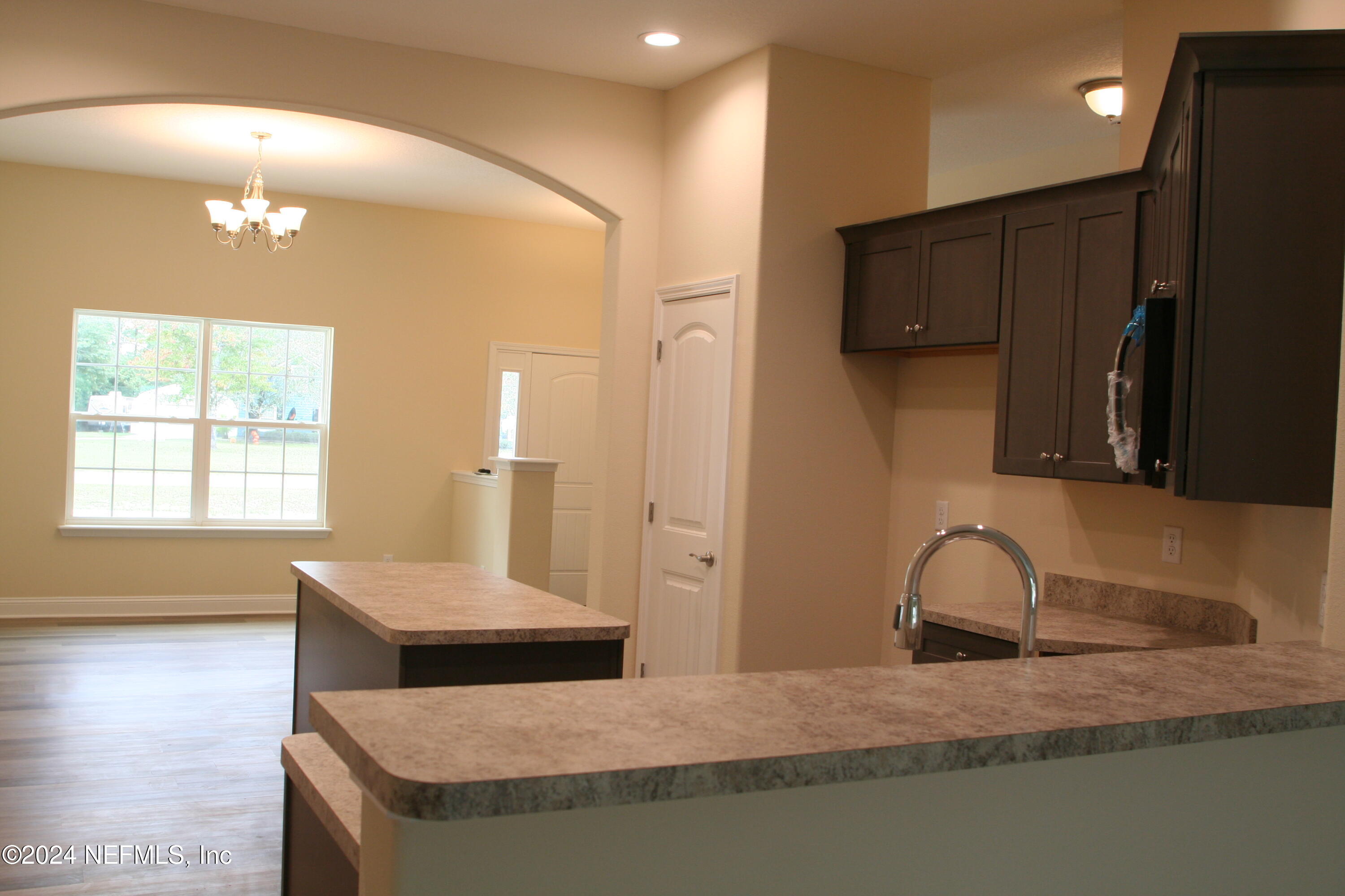 54516 Church Road Callahan, FL 32011 - Photo 39 of 39 a kitchen with stainless steel appliances granite countertop a sink a refrigerator and a granite counter tops