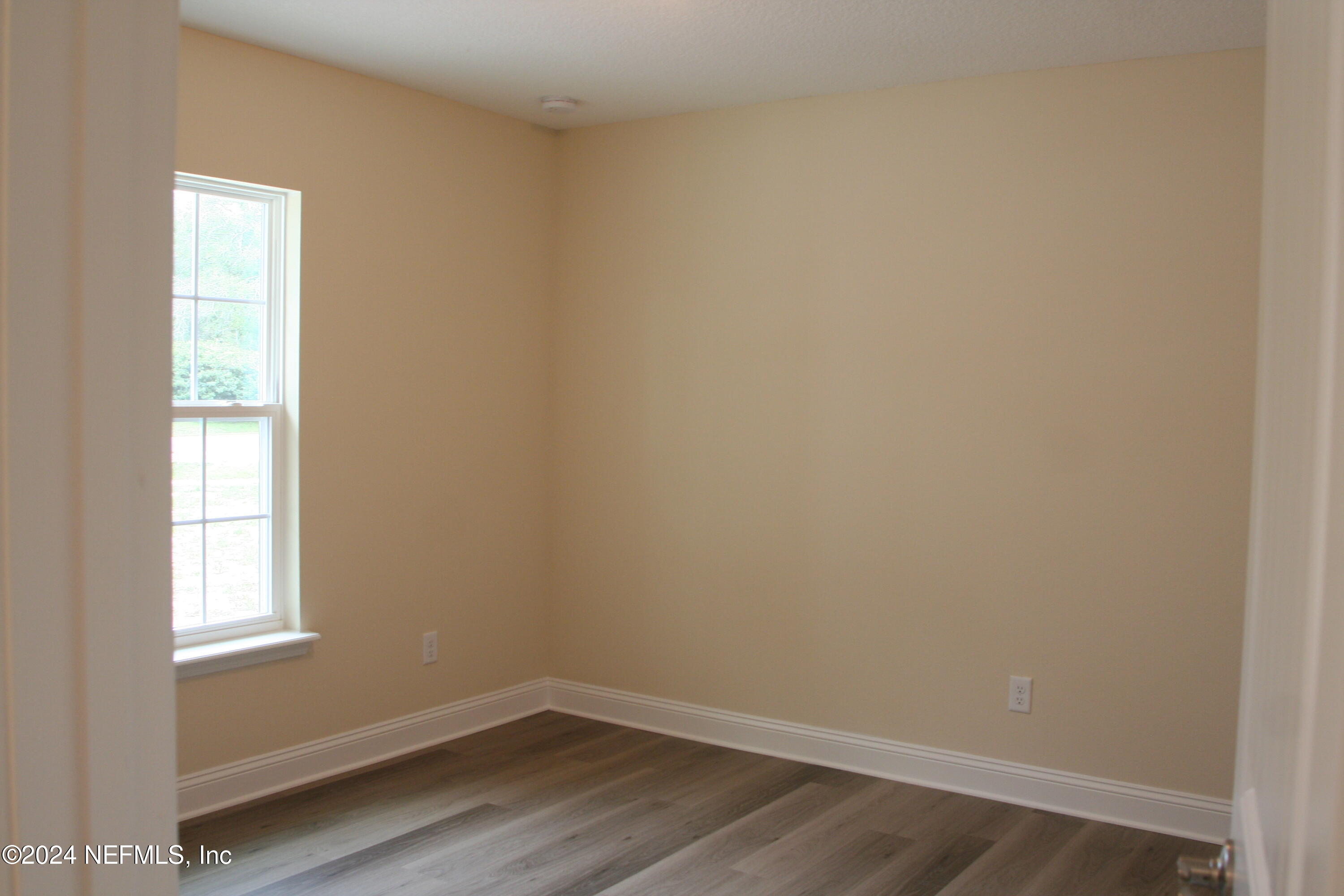 54516 Church Road Callahan, FL 32011 - Photo 8 of 39 a view of a small space with wooden floor and a window