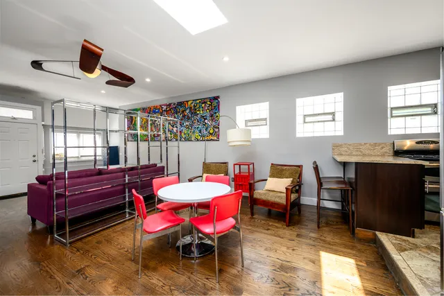 a living room with furniture a ceiling fan and a window