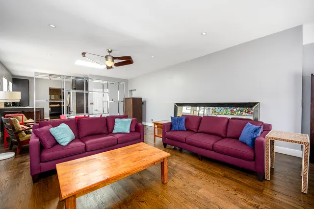 a living room with furniture a ceiling fan and a rug