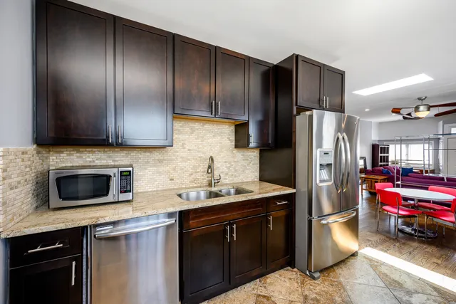 a kitchen with a refrigerator sink and microwave