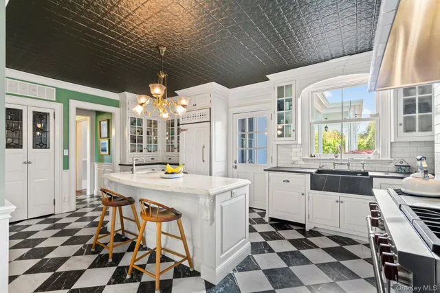 a kitchen with stainless steel appliances a stove a sink and a refrigerator