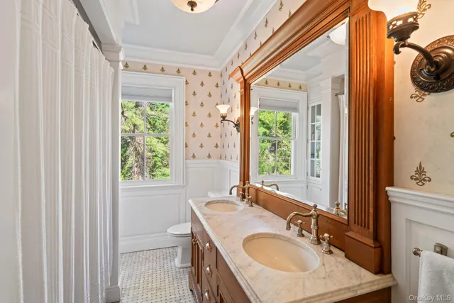 a bathroom with a sink a mirror and a window