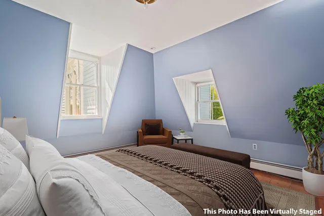 a bedroom with a bed and a window