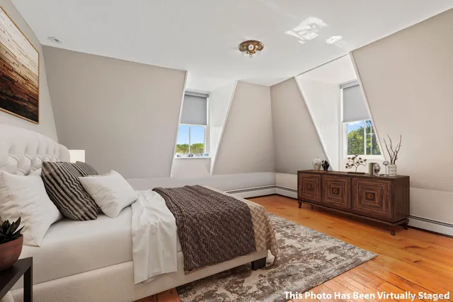 a bedroom with a bed dresser and a window