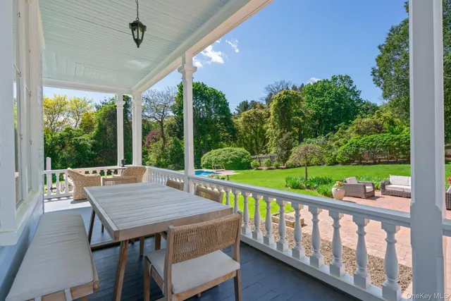 a view of a patio with a table chairs and a porch