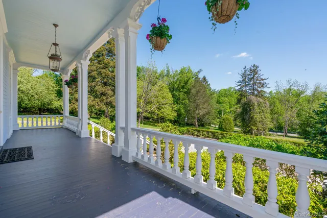 a view of a balcony with wooden floor