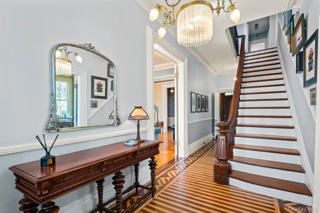 a view of entryway and hall with wooden floor
