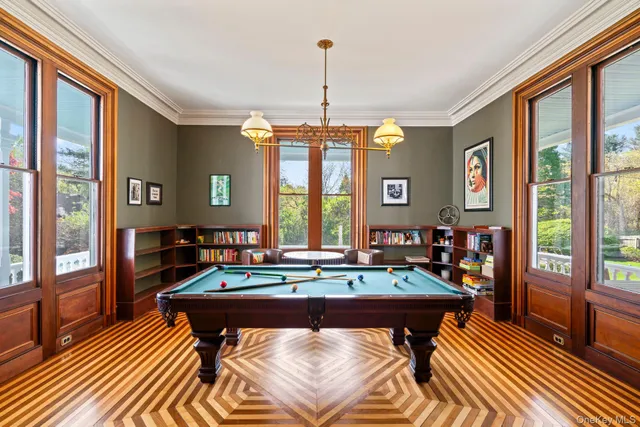a living room with furniture a table and large windows
