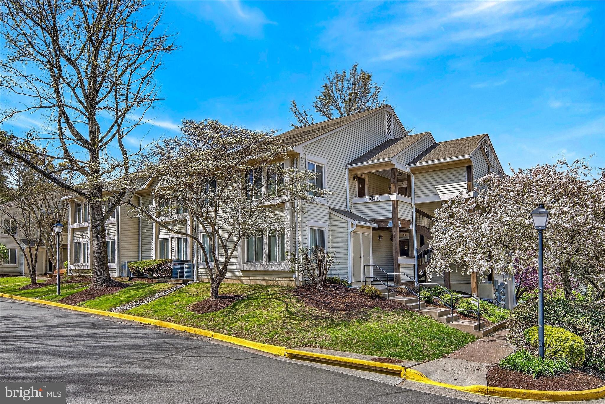 10340 Luria Commons Court, Unit 3H Burke, VA 22015 - Photo 1 of 21 a front view of a house with garden