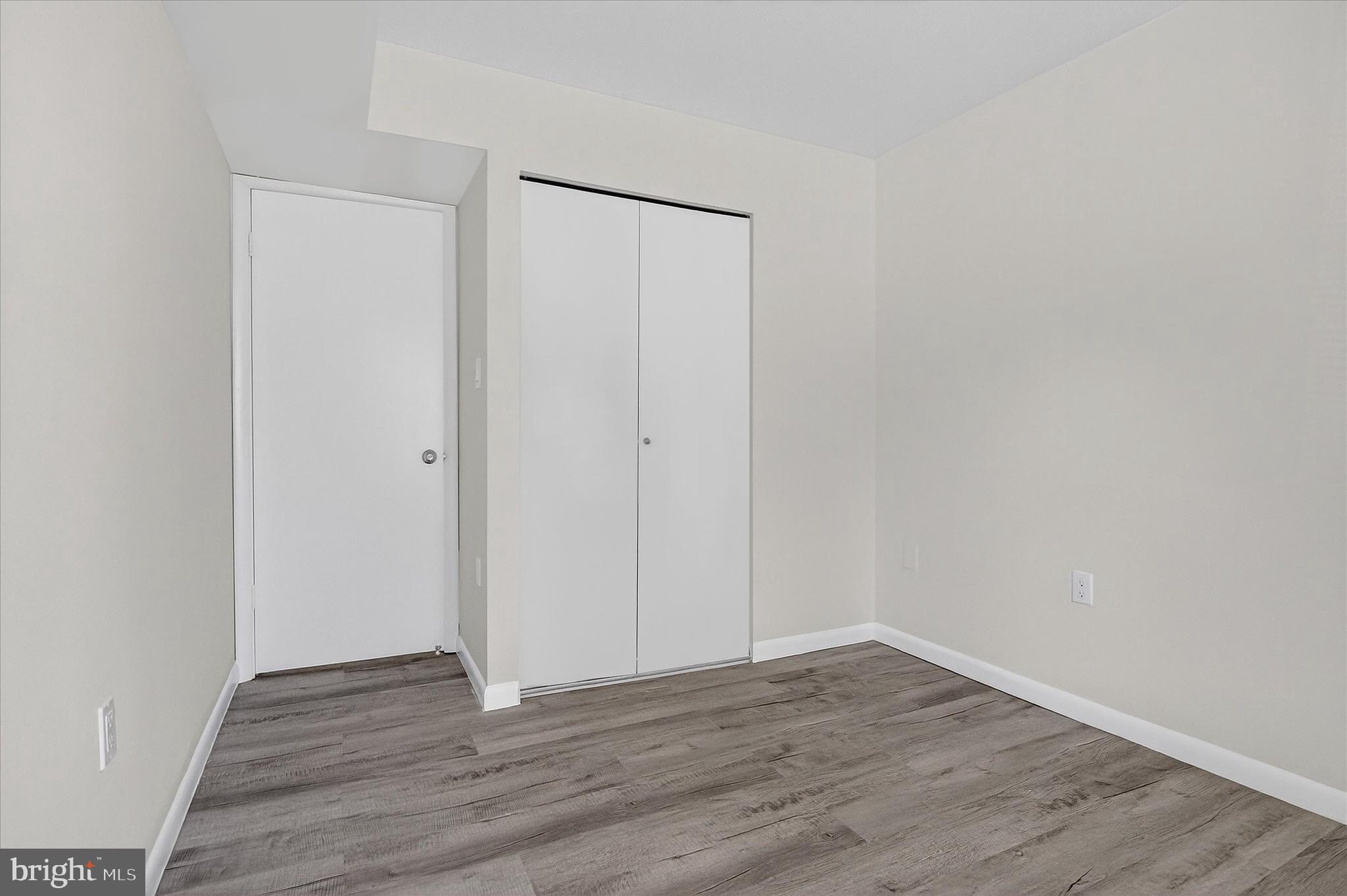 10340 Luria Commons Court, Unit 3H Burke, VA 22015 - Photo 12 of 21 a view of an empty room with wooden floor