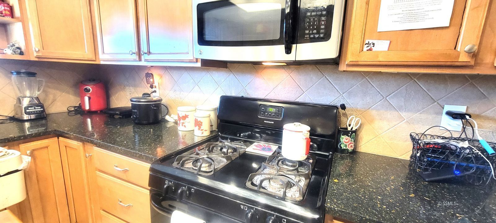 340 East Upjohn Avenue Ridgecrest, CA 93555 - Photo 10 of 31 a kitchen with a stove and a microwave
