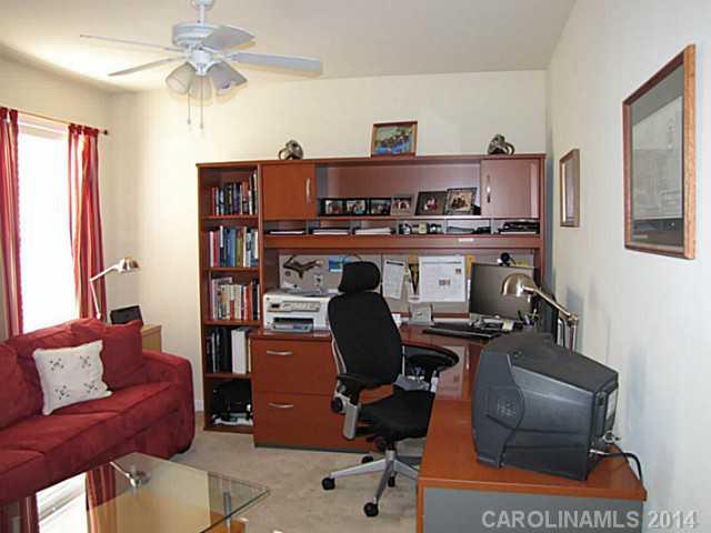 14112 Wild Elm Road Charlotte, NC 28277 - Photo 11 of 16 a work room with furniture and a chandelier fan