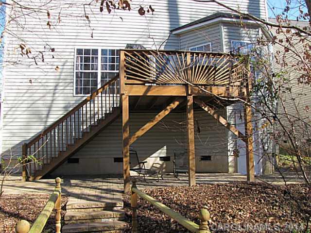 14112 Wild Elm Road Charlotte, NC 28277 - Photo 13 of 16 a backyard of a house with wooden fence and deck