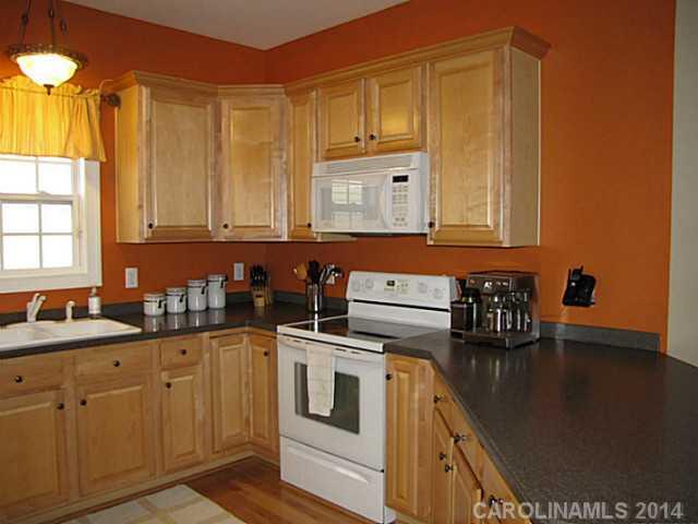 14112 Wild Elm Road Charlotte, NC 28277 - Photo 6 of 16 a kitchen with stainless steel appliances a sink a stove and cabinets