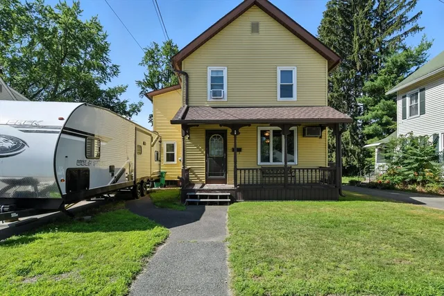 a front view of a house with a yard