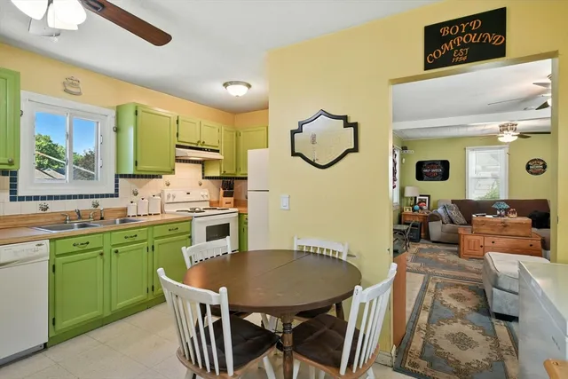 a kitchen with a table chairs sink and cabinets