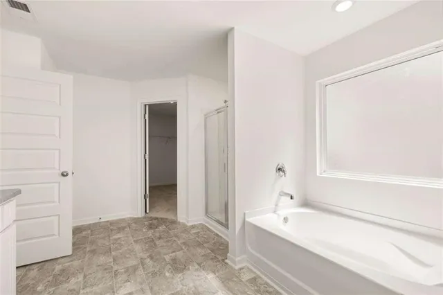 a bathroom with a shower and a bathtub