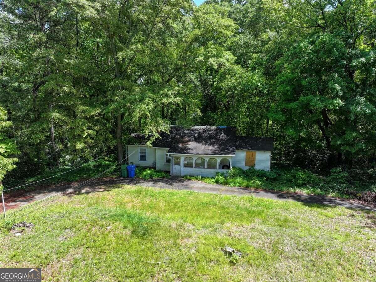 731 Bolton Road Northwest Atlanta, GA 30331 - Photo 1 of 7 a view of backyard with a table and chairs and potted plants