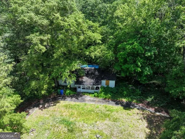 a backyard of a house with a yard and outdoor seating