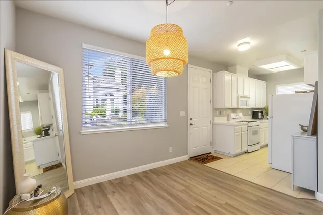 a kitchen with stainless steel appliances granite countertop a stove a refrigerator and a microwave