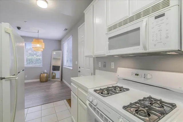 a kitchen with a stove a sink and a microwave